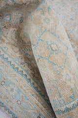 A hand knotted Persian runner from the Tabriz region. Featuring an intricate pattern in blue and beige tones