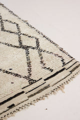 Indie is a vintage Beni Ourain with a geomectric black and cream design featuring tribal symbology.