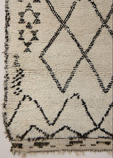 Indie is a vintage Beni Ourain with a geomectric black and cream design featuring tribal symbology.