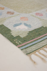 Trudie is an original Swedish röllakan rug handwoven by mid-century textile designer Anna Johanna Angström. Green colour-way featuring floral motifs