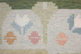 Trudie is an original Swedish röllakan rug handwoven by mid-century textile designer Anna Johanna Angström. Green colour-way featuring floral motifs