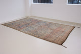 Sylvie is a peach and dark blue geometric patterned vintage Beni Ourain rug with a thick, cozy pile.