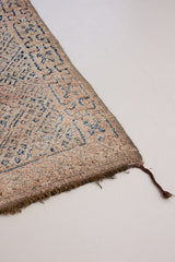 Sylvie is a peach and dark blue geometric patterned vintage Beni Ourain rug with a thick, cozy pile.