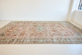 A huge, beautiful Mahal carpet, with an intricate floral motif in blue, red and greens.