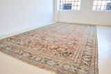 A huge, beautiful Mahal carpet, with an intricate floral motif in blue, red and greens.
