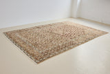 Dusty is an antique Mahal carpet featuring a beautiful intricate floral motif in pinks, beige and dark brown