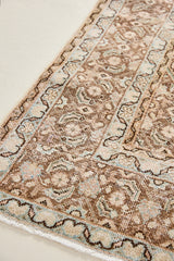 Dusty is an antique Mahal carpet featuring a beautiful intricate floral motif in pinks, beige and dark brown