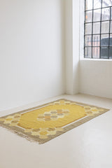 This is an original vintage Swedish flat weave carpet signed by the renowned textile designer Karin Jonsson. This rug features a palette of rich ochre yellow and a beautiful geometric design.