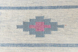 This rug shows beautiful tones of blue, this vintage kilim is featuring bold geometric design with hints of pink within the motifs in the carpet.