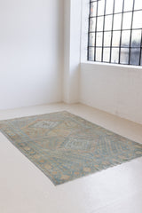 This is an Vintage Qashqai nomadic rug featuring a soft natural blue and orange with beautifully intricate designs within this handwoven carpet, a repeating boteh pattern frames the central diamond motifs.