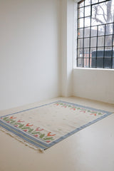 This colourful vintage kilim rug often feature strong lines and designs inspired by floral and botanical motifs.