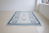 Mason is a vintage rug handwoven in Sweden, featuring a beautiful blue and pink colour palette and a rare large room size.