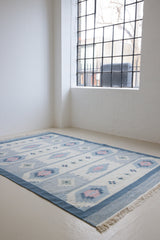 Mason is a vintage rug handwoven in Sweden, featuring a beautiful blue and pink colour palette and a rare large room size