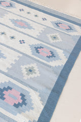 Mason is a vintage rug handwoven in Sweden, featuring a beautiful blue and pink colour palette and a rare large room size.