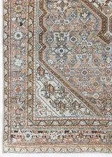 Dana is a handmade Malayer rug, woven in the North West of Iran. This antique carpet features the classic Hamadan bar medallion which is a diamond shape with an arrow emerging from each end, this is often associated with balance, protection and harmony.