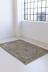 Dana is a handmade Malayer rug, woven in the North West of Iran. This antique carpet features the classic Hamadan bar medallion which is a diamond shape with an arrow emerging from each end, this is often associated with balance, protection and harmony.