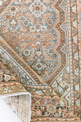 Dana is a handmade Malayer rug, woven in the North West of Iran. This antique carpet features the classic Hamadan bar medallion which is a diamond shape with an arrow emerging from each end, this is often associated with balance, protection and harmony.