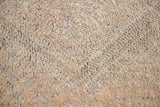 Textured thick pile antique Moroccan rug with a geometric pattern on a peach background