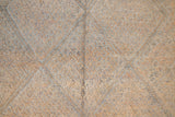 Textured thick pile antique Moroccan rug with a geometric pattern on a peach background