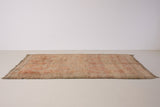 Aliya Beni M’guild vintage thick pile carpet. Peach coloured with a grey geometric pattern.