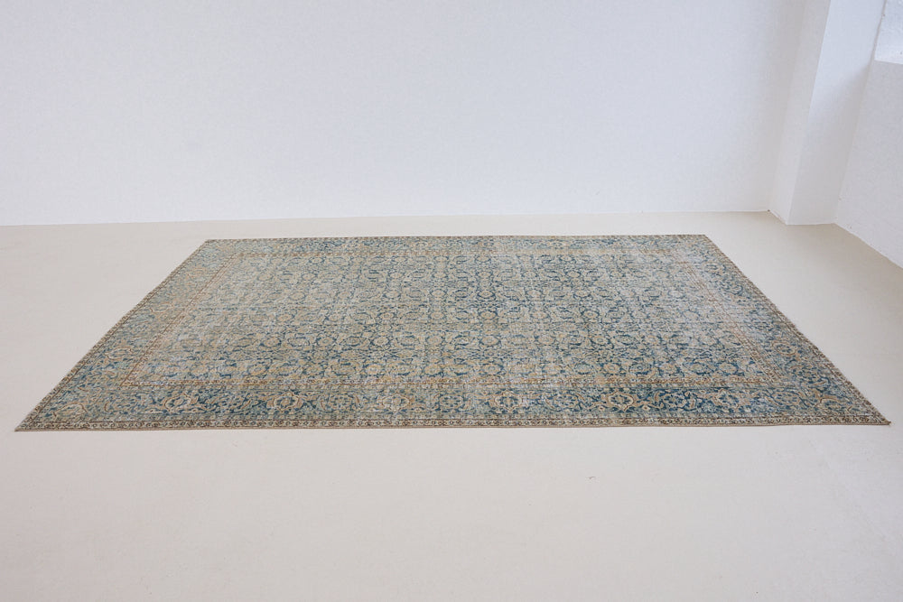 This is a handmade antique Tabriz rug, woven in Persia. The Tabriz region is known for producing some of the most ornate Persian carpets, often known for their mesmerising and intricate repeating patterns.