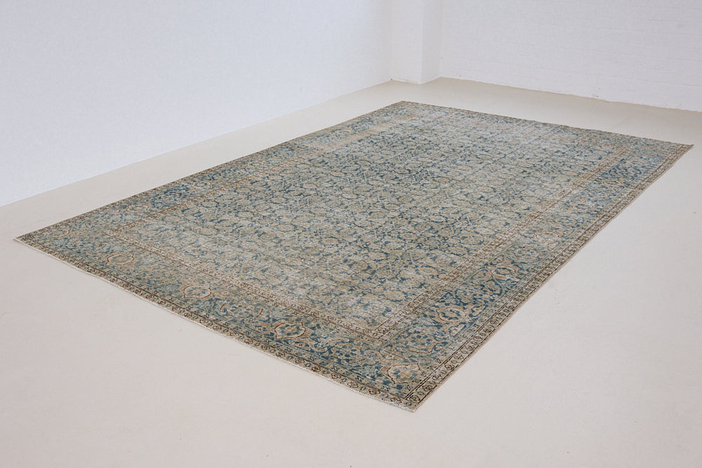 This is a handmade antique Tabriz rug, woven in Persia. The Tabriz region is known for producing some of the most ornate Persian carpets, often known for their mesmerising and intricate repeating patterns.