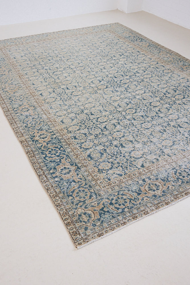 This is a handmade antique Tabriz rug, woven in Persia. The Tabriz region is known for producing some of the most ornate Persian carpets, often known for their mesmerising and intricate repeating patterns.