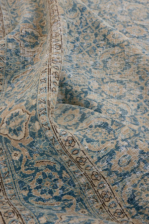 This is a handmade antique Tabriz rug, woven in Persia. The Tabriz region is known for producing some of the most ornate Persian carpets, often known for their mesmerising and intricate repeating patterns.
