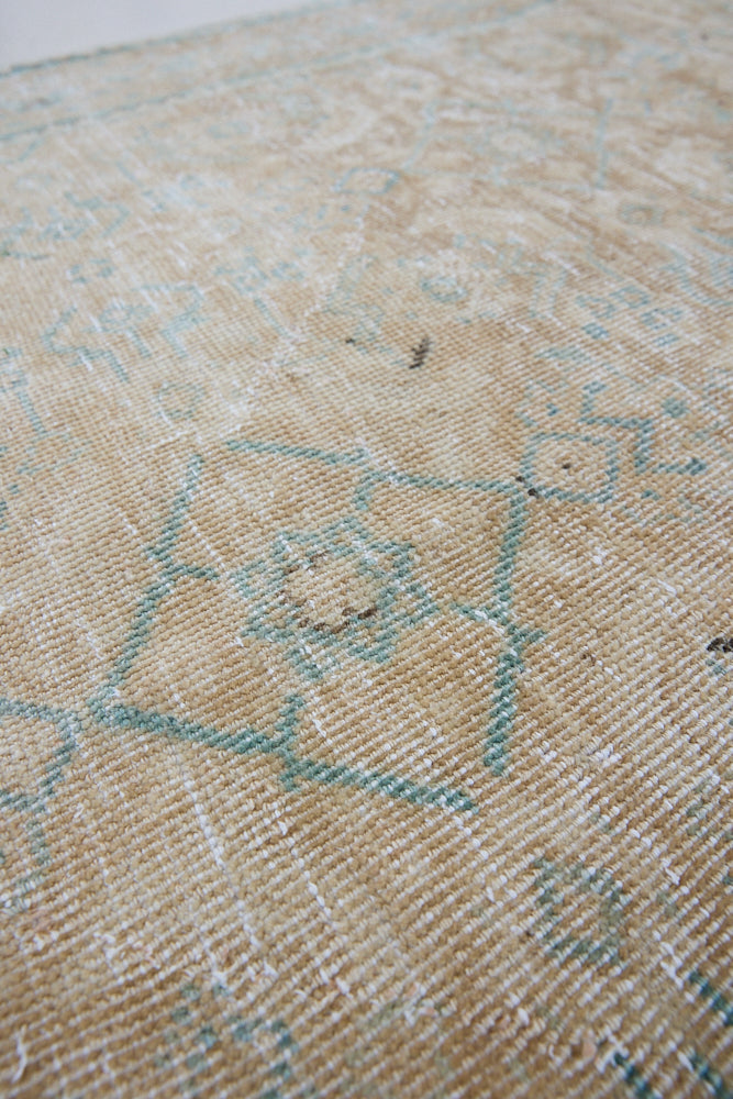A hand knotted Persian runner from the Tabriz region. Featuring an intricate pattern in blue and beige tones