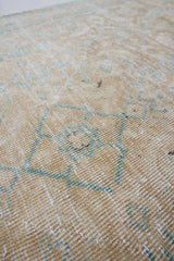 A hand knotted Persian runner from the Tabriz region. Featuring an intricate pattern in blue and beige tones