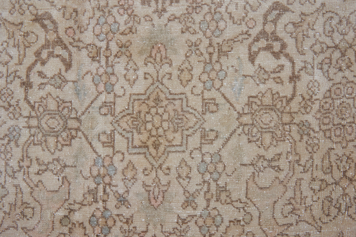 Cecil is a beautiful antique Persian Tabriz rug with a soft and subtle colour palette and in an extra large size. This pretty carpet features highly detailed flowers, palmettes, arabesques and leafy sprays throughout the field and borders, symbolising nature and beauty.