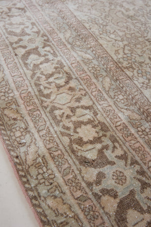 Cecil is a beautiful antique Persian Tabriz rug with a soft and subtle colour palette and in an extra large size. This pretty carpet features highly detailed flowers, palmettes, arabesques and leafy sprays throughout the field and borders, symbolising nature and beauty.