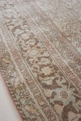 Cecil is a beautiful antique Persian Tabriz rug with a soft and subtle colour palette and in an extra large size. This pretty carpet features highly detailed flowers, palmettes, arabesques and leafy sprays throughout the field and borders, symbolising nature and beauty.