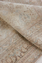 Cecil is a beautiful antique Persian Tabriz rug with a soft and subtle colour palette and in an extra large size. This pretty carpet features highly detailed flowers, palmettes, arabesques and leafy sprays throughout the field and borders, symbolising nature and beauty.