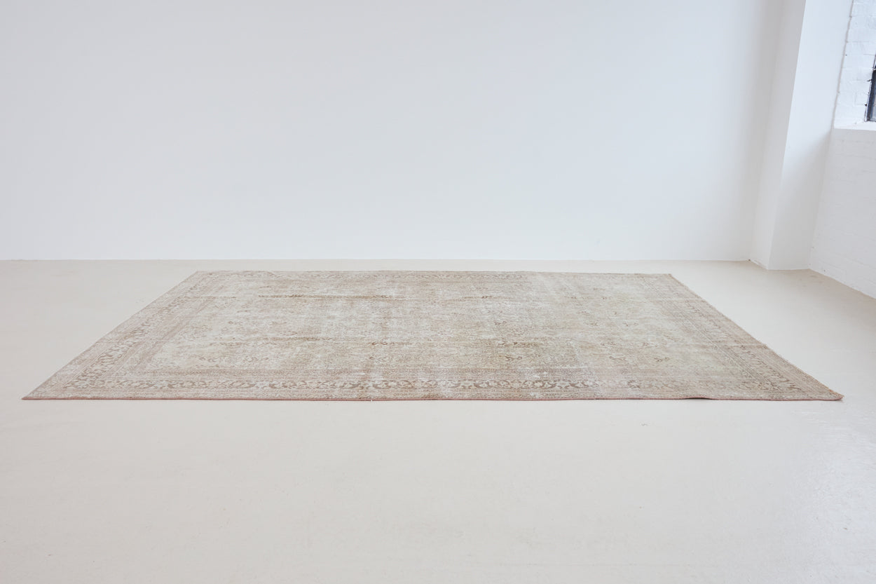 Cecil is a beautiful antique Persian Tabriz rug with a soft and subtle colour palette and in an extra large size. This pretty carpet features highly detailed flowers, palmettes, arabesques and leafy sprays throughout the field and borders, symbolising nature and beauty.