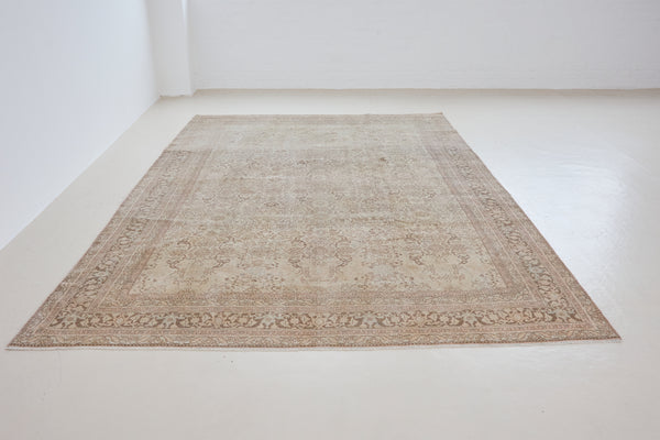 Cecil is a beautiful antique Persian Tabriz rug with a soft and subtle colour palette and in an extra large size. This pretty carpet features highly detailed flowers, palmettes, arabesques and leafy sprays throughout the field and borders, symbolising nature and beauty.