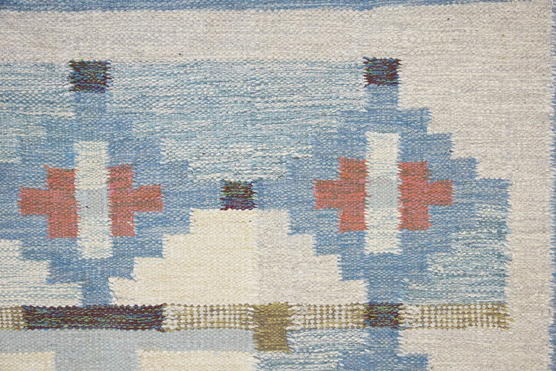 Erin is an original röllakan by the textile designer Karin Jonsson. This vintage rug features a beautiful and unique blue, pink and green colour palette and a geometric design.