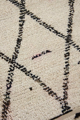 Indie is a vintage Beni Ourain with a geomectric black and cream design featuring tribal symbology.