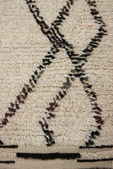 Indie is a vintage Beni Ourain with a geomectric black and cream design featuring tribal symbology.