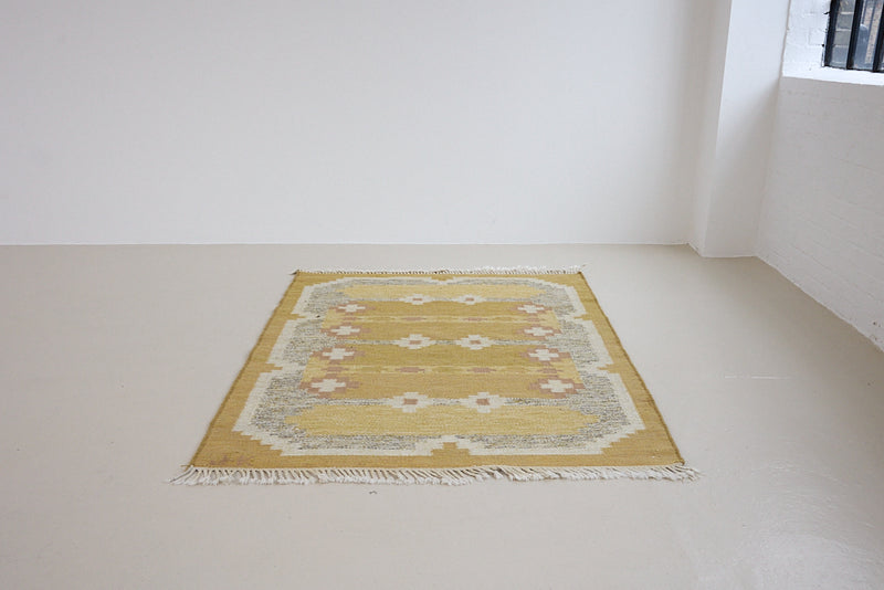 Luisa is a Swedish röllakan rug by textile designer Karin Jonsson. This unique rug features a beautiful ochre yellow colour palette and a geometric design