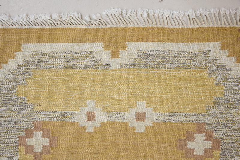 Luisa is a Swedish röllakan rug by textile designer Karin Jonsson. This unique rug features a beautiful ochre yellow colour palette and a geometric design