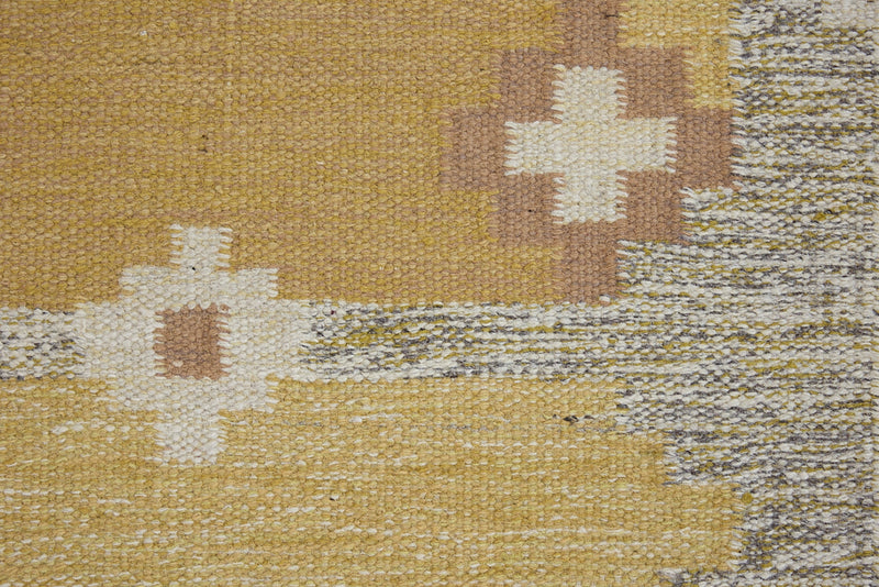 Luisa is a Swedish röllakan rug by textile designer Karin Jonsson. This unique rug features a beautiful ochre yellow colour palette and a geometric design