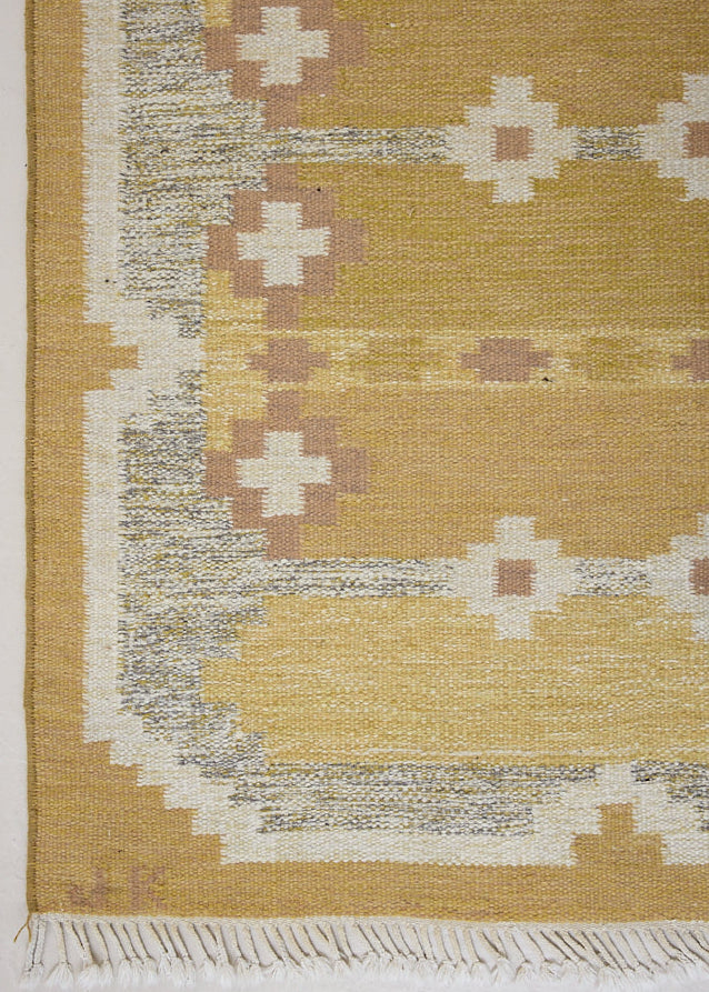 Luisa is a Swedish röllakan rug by textile designer Karin Jonsson. This unique rug features a beautiful ochre yellow colour palette and a geometric design