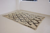 Remi is a vintage Beni Ourain from the middle Atlas mountains, with a rare design featuring tribal symbology. Thick natural wool carpet in black and white pattern.