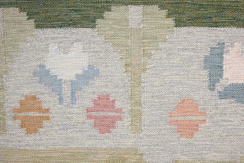 Trudie is an original Swedish röllakan rug handwoven by mid-century textile designer Anna Johanna Angström. Green colour-way featuring floral motifs 