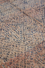 Sylvie is a peach and dark blue geometric patterned vintage Beni Ourain rug with a thick, cozy pile. 