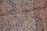 Sylvie is a peach and dark blue geometric patterned vintage Beni Ourain rug with a thick, cozy pile. 