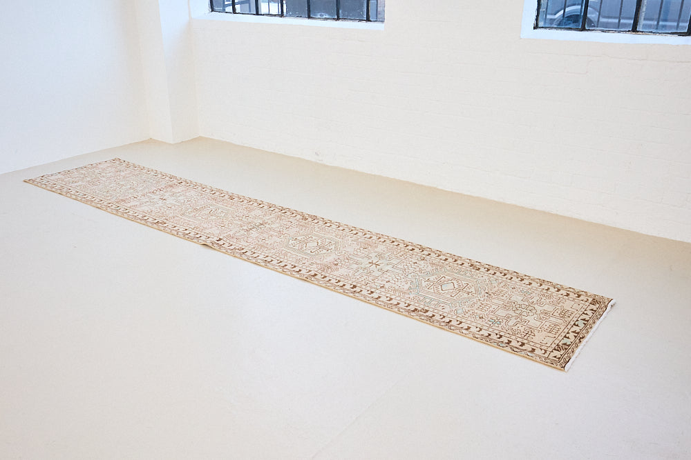 This is an vintage Persian Heriz runner which has been antique washed. Heriz carpets are some of the most sought after Persian designs and this rug features a classic Heriz design in gorgeous soft blue, taupe and cream tones. 