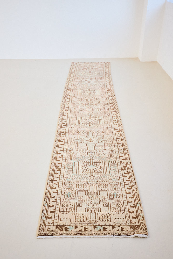 This is an vintage Persian Heriz runner which has been antique washed. Heriz carpets are some of the most sought after Persian designs and this rug features a classic Heriz design in gorgeous soft blue, taupe and cream tones. 