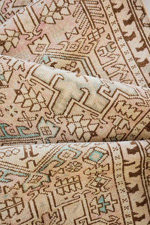 This is an vintage Persian Heriz runner which has been antique washed. Heriz carpets are some of the most sought after Persian designs and this rug features a classic Heriz design in gorgeous soft blue, taupe and cream tones. 